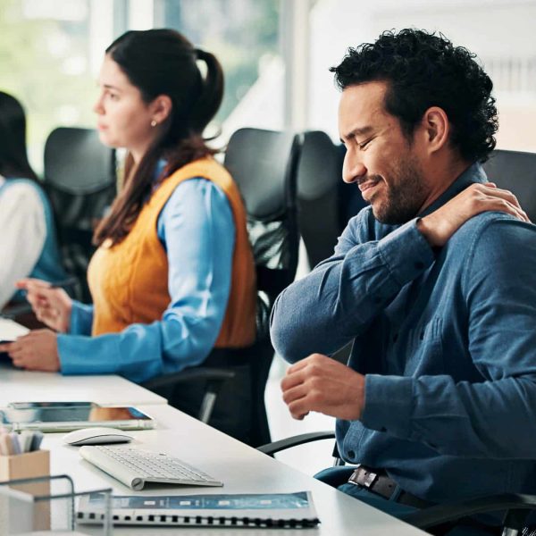 Computer, business man or shoulder pain in office with muscle fatigue, article pressure or workload. Coworking, journalist or joint ache at publishing agency from poor posture or overworked on story